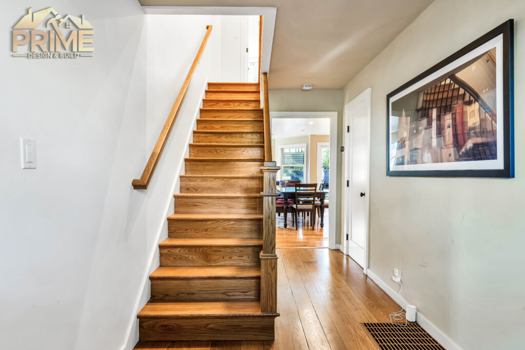 The homeowners wanted their remodeled space to feel fresh and functional without losing its historic character. This meant every decision, from the layout to the materials, had to strike the perfect balance. We rebuilt the upstairs including reconstruction of the existing bathroom to make an impressive master bathroom and dressing room, and refinished the hardwood floors to preserve the details that tied back to the home’s 1937 roots. By incorporating traditional elements like marble floors and walls in the bathroom , aged wood vanities and new crown molding for the whole upstairs, we ensured the updated design felt authentic and timeless.